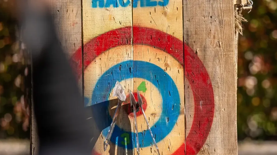 Cible de lancer de hache UniGames avec plusieurs haches plantées
